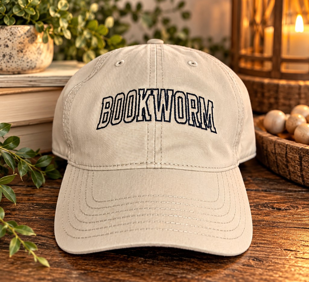 Beige baseball cap embroidered with the word Bookworm